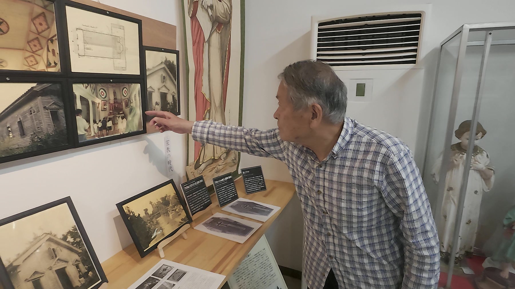 久賀島潜伏キリシタン資料館で資料を指しながら説明する館長